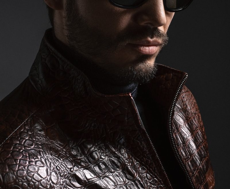 man wearing black leather jacket and sunglasses