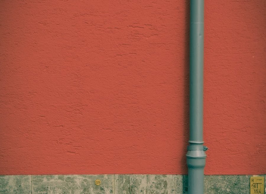 a red wall with a blue street light next to it
